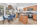 Bright breakfast nook with natural light, a stylish light fixture, and a round table for cozy dining at 756 Arden Valley Ave, Henderson, NV 89011