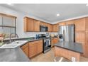 Well-appointed kitchen featuring granite counters, stainless steel appliances, and natural wood cabinetry at 756 Arden Valley Ave, Henderson, NV 89011