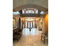 Elegant foyer featuring high ceilings, wrought iron accents, and arched doorways leading to other areas of the home at 7625 Coley Ave, Las Vegas, NV 89117