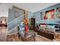 Comfortable living room features a staircase and hardwood flooring at 7651 Anatolian St, Las Vegas, NV 89166