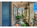Inviting front porch with chairs, plants, and charming decor at 7651 Anatolian St, Las Vegas, NV 89166