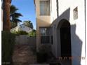 Side entrance featuring a stone walkway and mature landscaping at 7840 Millhopper Ave, Las Vegas, NV 89128