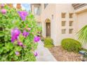 Close-up of home's entrance showing desert landscaping, pathway, and inviting front door at 7840 Millhopper Ave, Las Vegas, NV 89128
