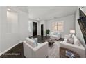 Bright living room featuring neutral decor, white furniture, dark floors, and ample natural light at 8029 Chablis Bay St, Las Vegas, NV 89131