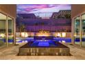 Beautiful backyard showcasing a modern pool, jacuzzi, and water feature, framed by sliding glass doors to the home's interior at 819 Bolide St, Las Vegas, NV 89138