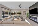 Bright living room with modern furniture, a sleek fireplace, and sliding glass doors to the outdoor space at 819 Bolide St, Las Vegas, NV 89138