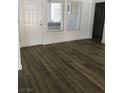 Living room showcasing wood laminate floors, natural light from windows, and neutral paint at 8901 Kingsmill Dr, Las Vegas, NV 89134