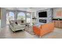Bright living room with modern fireplace, complemented by large windows and stylish furnishings at , Las Vegas, NV 89146