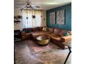 Spacious living room featuring a large sectional sofa, area rug, and modern decor at 10403 Fancy Fern St, Las Vegas, NV 89183