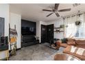 Inviting living room featuring a comfortable leather couch, modern entertainment center, and stylish décor at 10403 Fancy Fern St, Las Vegas, NV 89183
