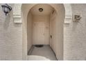 Charming entry with a decorative archway that leads to the front door of the residence at 10550 W Alexander Rd # 2233, Las Vegas, NV 89129