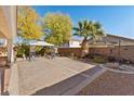 Spacious backyard featuring a patio area, a gazebo, desert landscaping, and block wall fencing at 11132 Ferragamo Ct, Las Vegas, NV 89141