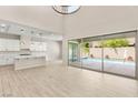 A contemporary kitchen that flows into the great room with stainless steel appliances and quartz countertops at 12048 Portamento Ct, Las Vegas, NV 89138