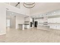 Bright and airy living space featuring soaring ceilings, modern finishes, and an open-concept kitchen at 12048 Portamento Ct, Las Vegas, NV 89138