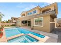 Inviting backyard pool and spa with tanning ledge and outdoor living space, perfect for relaxation and entertaining at 12048 Portamento Ct, Las Vegas, NV 89138