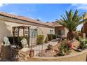 Attractive front yard with lush greenery, decorative lion statues, and a charming gated entrance at 1223 Golf Club Dr, Laughlin, NV 89029