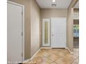 Inviting entryway with tile flooring, neutral paint, and a stylish front door with sidelight at 1561 Campfire Ln, Mesquite, NV 89034