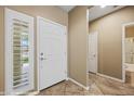 Bright entryway featuring tile flooring, neutral paint, and a paneled front door with sidelight at 1561 Campfire Ln, Mesquite, NV 89034