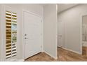 Bright entryway featuring tiled floors, a side window, and a white front door at 1561 Campfire Ln, Mesquite, NV 89034