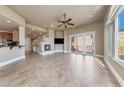 Spacious living room featuring a fireplace, tile flooring, and access to the balcony at 16 Cerchio Basso, Henderson, NV 89011