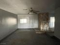 Interior view of a living room with a stone fireplace and neutral walls at 204 Bradshaw Way, Las Vegas, NV 89145