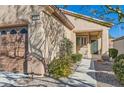 Close up of the front of the home, with desert landscaping, and a two car garage at 2152 Mountain City St, Henderson, NV 89052