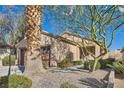 Charming single-story home with desert landscaping and a two-car garage under a clear sky at 2152 Mountain City St, Henderson, NV 89052