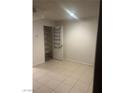 Bedroom featuring ceramic tile flooring, a closet with shelves, and white walls at 220 Mission Newport Ln # 201, Las Vegas, NV 89107