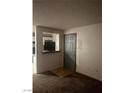 Inviting entryway with wood floors and a view into the kitchen area at 220 Mission Newport Ln # 201, Las Vegas, NV 89107