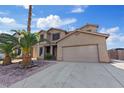 Inviting two-story home showcasing a two-car garage and desert-friendly landscaping at 227 Palmarosa St, Henderson, NV 89015