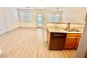 Updated kitchen featuring modern appliances, double sink, and wood-look flooring at 2524 Charleville Ave # 102, Las Vegas, NV 89106