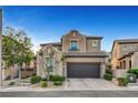 Charming two-story home with a well-maintained front yard, dark brown garage doors, and desert landscaping at 305 Rezzo St, Las Vegas, NV 89138