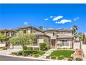 Elegant home showcases a manicured lawn, mature trees, and a unique circular architectural design at 3552 Coventry Gardens Dr, Las Vegas, NV 89135