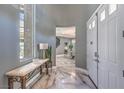 Grand foyer with marble floors, stylish console table, and a view of the dining area at 3552 Coventry Gardens Dr, Las Vegas, NV 89135