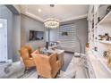 Modern home office with custom built-ins, contemporary chandelier, and comfortable seating at 3552 Coventry Gardens Dr, Las Vegas, NV 89135