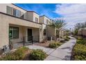 Street view of modern townhomes with neutral stucco facade, sidewalk, and well-maintained landscaping at 3585 Arcadian Sea St, Las Vegas, NV 89106
