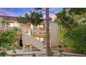 Charming condo showcases stucco facade, stairway access, and verdant trees at 3740 Desert Marina Dr # 2, Laughlin, NV 89029