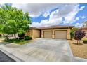 Lovely single-story home featuring a two-car garage, well-manicured lawn, and xeriscaping at 4 Chatmoss Rd, Henderson, NV 89052