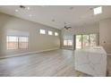 Spacious living room boasts wood floors, recessed lighting, ceiling fan and windows overlooking the outdoor space at 4 Chatmoss Rd, Henderson, NV 89052