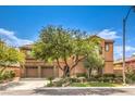 Beautiful multi-story house showcasing landscaped front yard, stone accents, and an attached three-car garage at 409 Lake Windemere St, Las Vegas, NV 89138