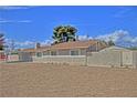 A single-story home with a carport and desert-friendly landscaping, including a block wall for privacy at 4211 Bradley Rd, Las Vegas, NV 89130