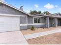 Home exterior with attached garage, gravel landscaping and updated paint scheme at 4620 Pacer Ave, North Las Vegas, NV 89031