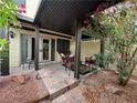 Relaxing covered patio featuring outdoor seating and lovely landscaping at 4662 Kelly Barry Way, Las Vegas, NV 89121