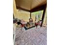 Charming covered patio with brick flooring, wicker furniture, and a relaxing outdoor ambiance at 4662 Kelly Barry Way, Las Vegas, NV 89121