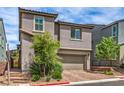 Charming two-story home featuring a well-maintained landscape and a two-car garage at 48 Verde Rosa Dr, Henderson, NV 89011