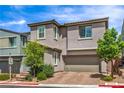 Charming two-story home featuring a well-maintained landscape and a two-car garage at 48 Verde Rosa Dr, Henderson, NV 89011