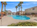 Inviting community pool area with palm trees, lounge chairs, and covered seating at 50 Belle La Blanc Ave, Las Vegas, NV 89123