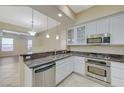 White kitchen with granite counters and stainless steel dishwasher, range, and microwave at 50 E Serene Ave # 420, Las Vegas, NV 89123