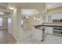 Bright kitchen features stainless steel appliances, a breakfast bar, and tile flooring at 50 E Serene Ave # 420, Las Vegas, NV 89123