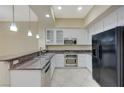 Modern kitchen showcasing stainless steel appliances, granite countertops, and stylish pendant lighting at 50 E Serene Ave # 420, Las Vegas, NV 89123
